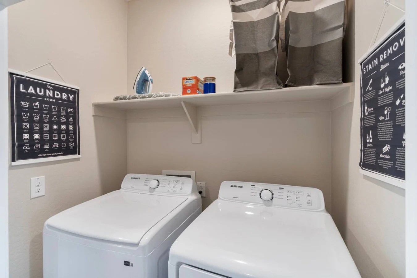 As you step into the laundry room, the modern appliances make it easy to keep things tidy.