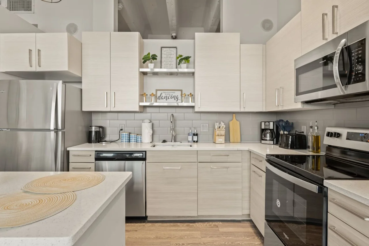 This contemporary kitchen is a chef's dream, featuring a large island, modern stainless steel appliances, and sleek cabinetry. The open layout ensures you can cook and entertain effortlessly, making it the perfect space for culinary creativity and social