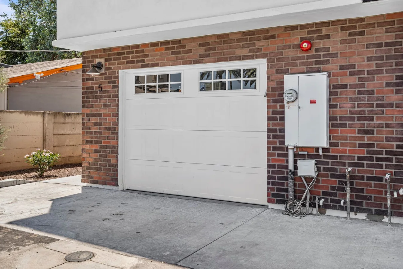 The house’s exterior is a blend of modern and classic design elements, creating a welcoming and stylish facade.