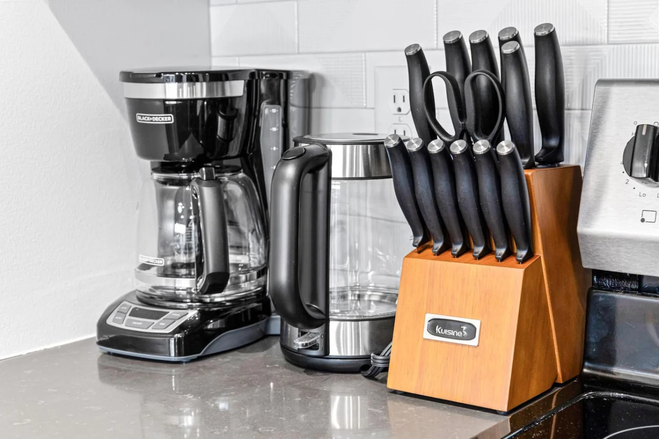Kitchen cabinets stocked with cooking wares, glassware and silverwares, ideal for mixing up your favorite meals and drinks during your stay.