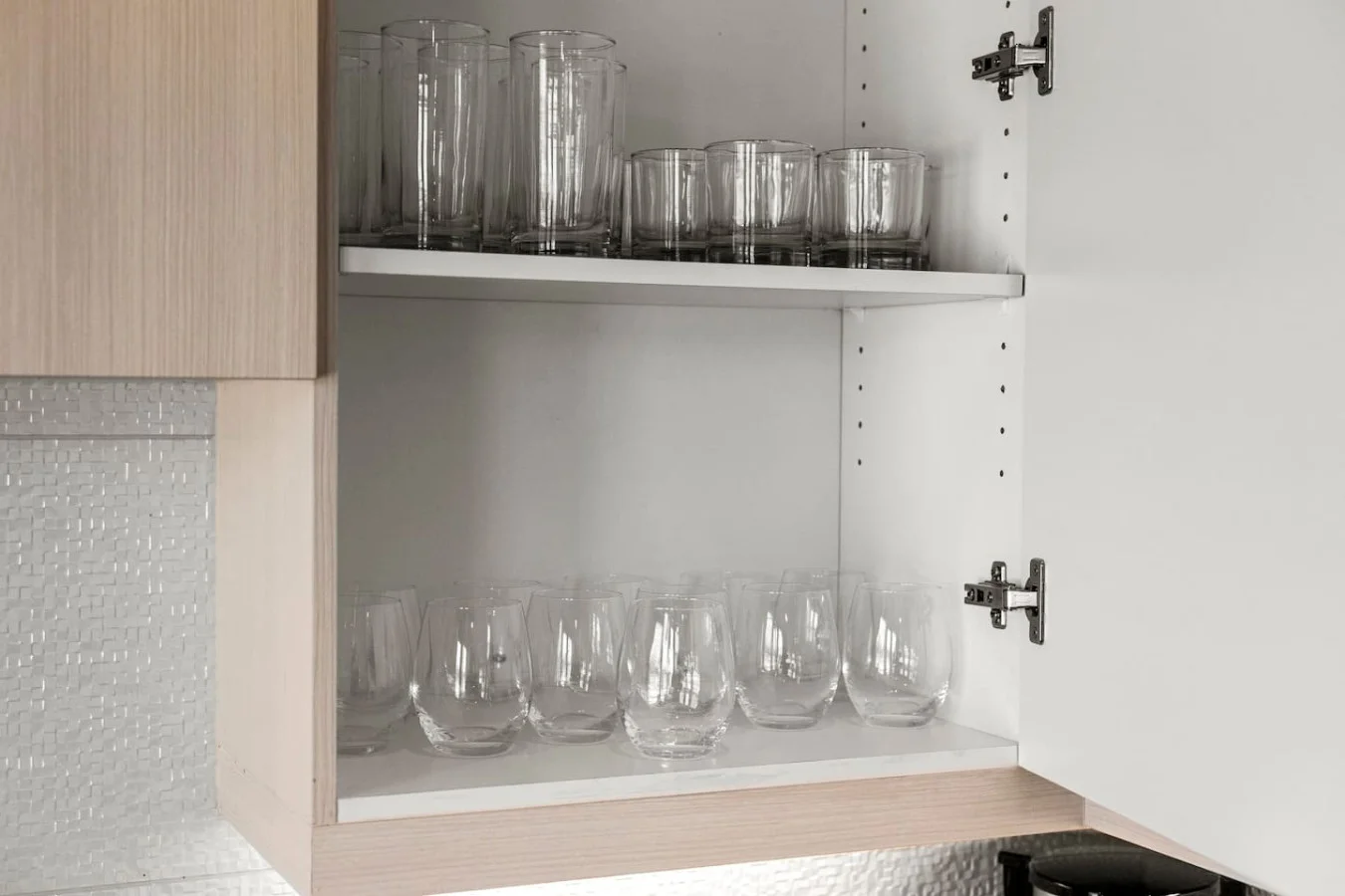 Kitchen cabinets stocked with cooking wares, glassware and silverwares, ideal for mixing up your favorite meals and drinks during your stay.