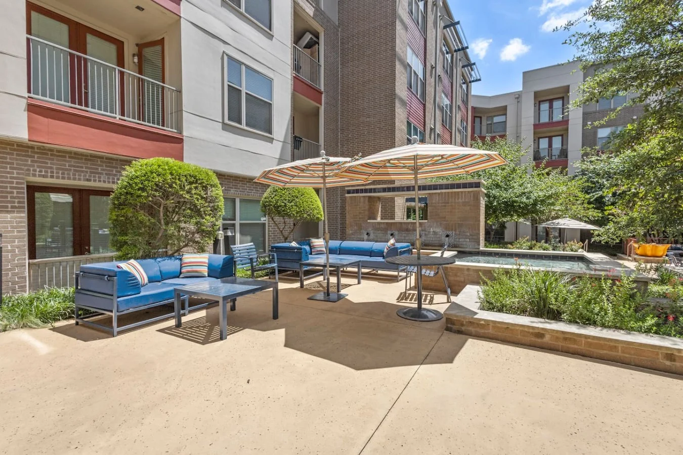 "Tranquil courtyard living with plush outdoor sofas."