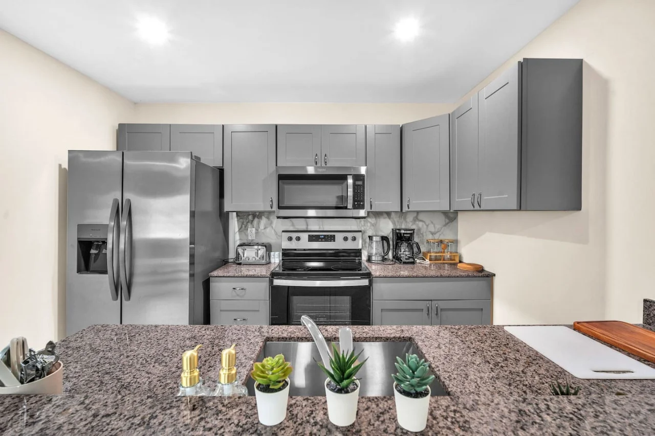 Cook with ease in this well-equipped kitchen featuring stainless steel appliances, ample cabinetry, and a stylish backsplash. Whether you're brewing coffee or preparing a gourmet meal, this space is designed for functionality and style, making every meal