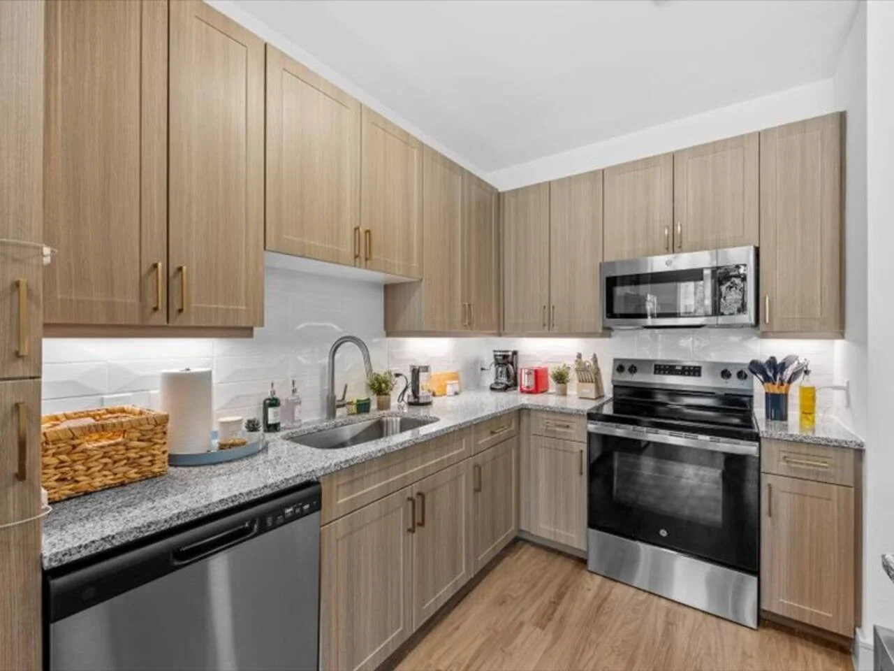 Cook with ease in this well-equipped kitchen featuring stainless steel appliances, ample cabinetry, and a stylish backsplash. Whether you're brewing coffee or preparing a gourmet meal, this space is designed for functionality and style, making every meal
