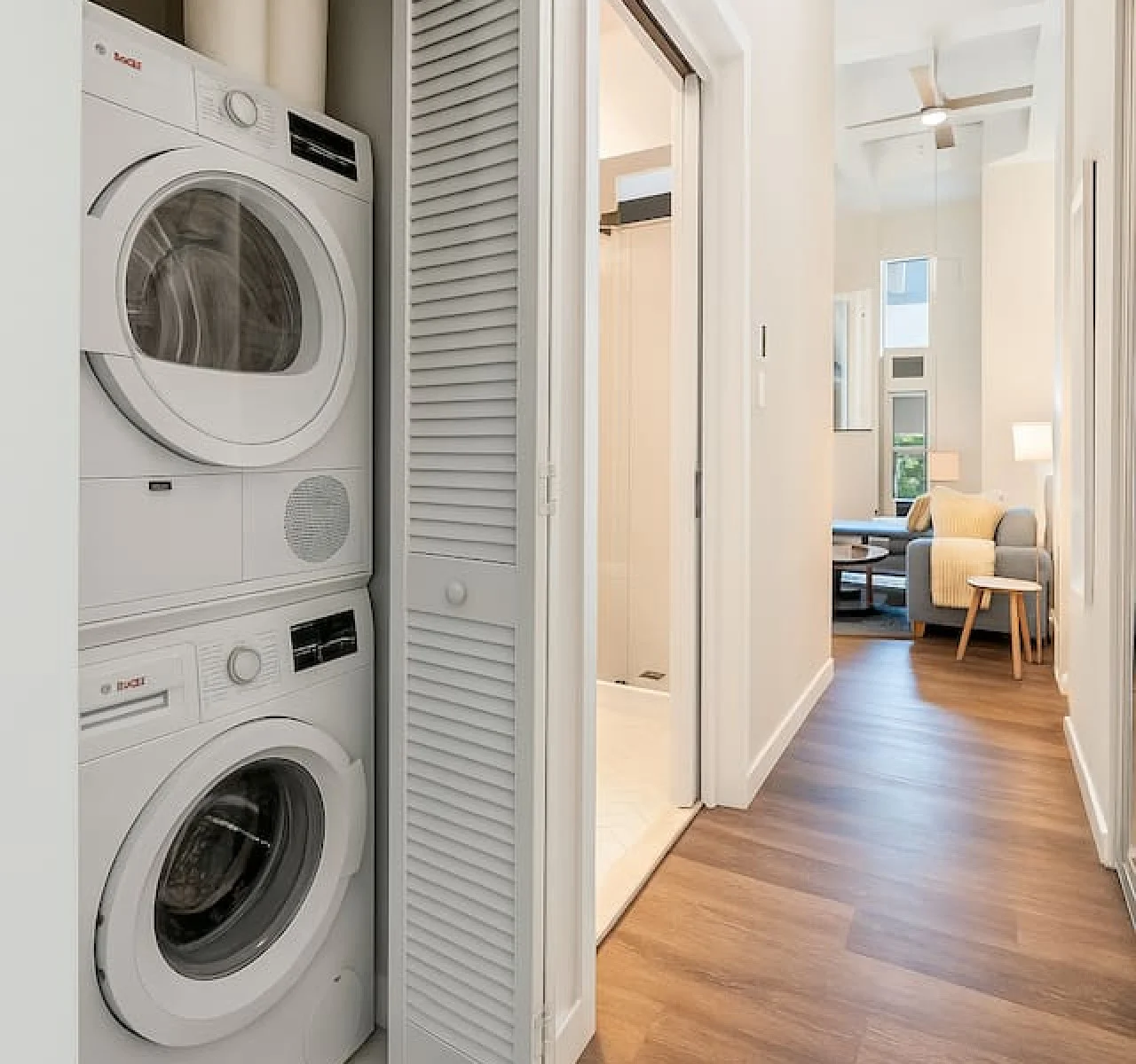 As you step into the laundry room, the modern appliances and ample storage space make it easy to keep things tidy.