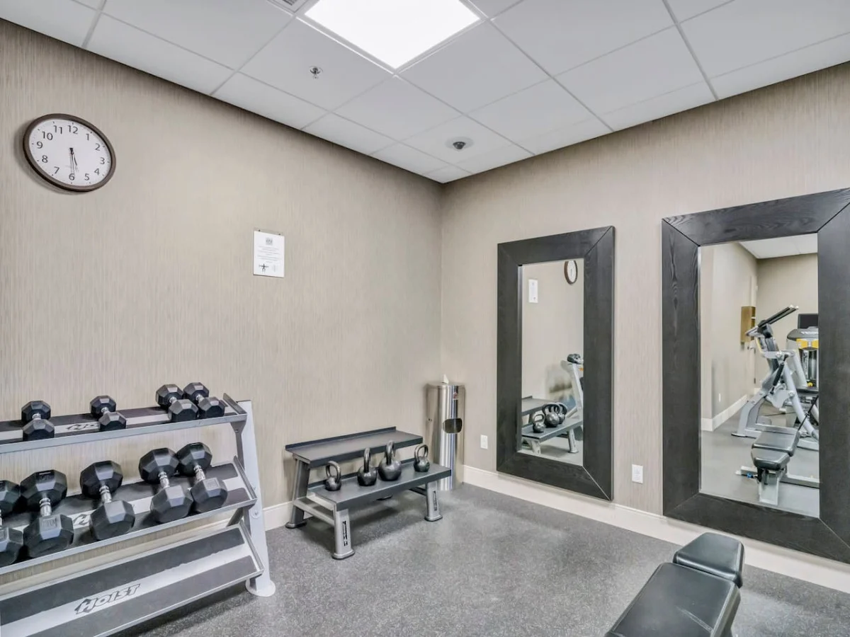 Dedicated space featuring a wide range of dumbbells, benches, and mirrors for strength and resistance training