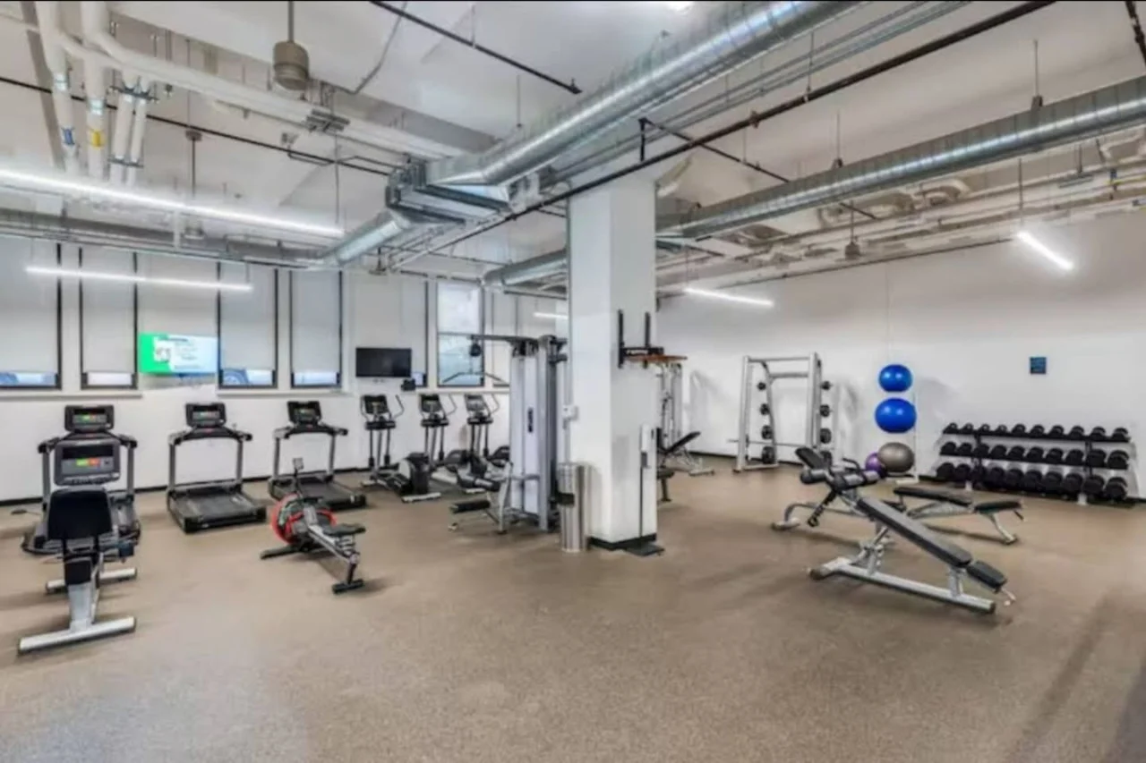 Open floor area with exercise mats, yoga balls, and foam rollers for warm-ups, stretching, or core exercises.