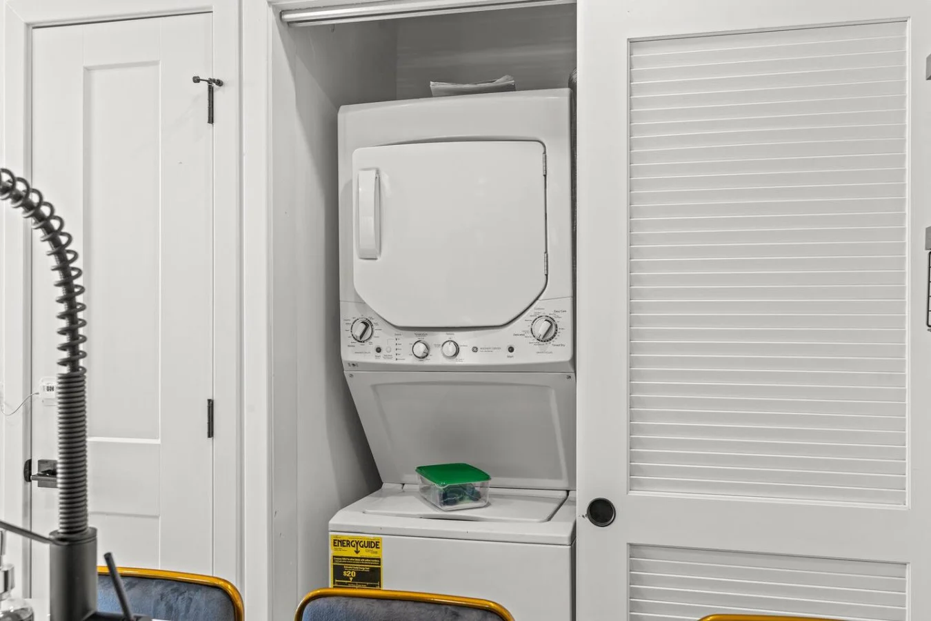 Laundry room with a washer, dryer, and folding area, offering all the convenience you need for a comfortable extended stay.