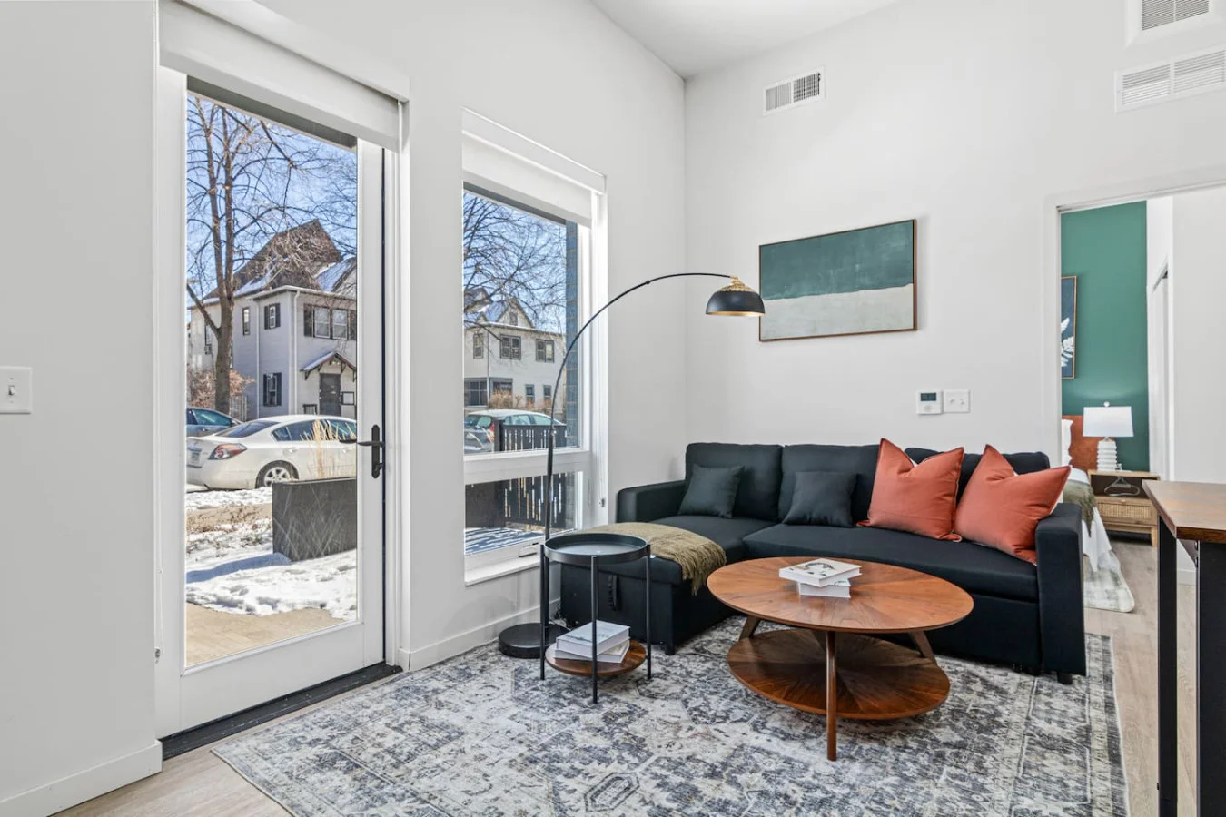 The living room is filled with natural light, creating a bright and welcoming space that invites relaxation.