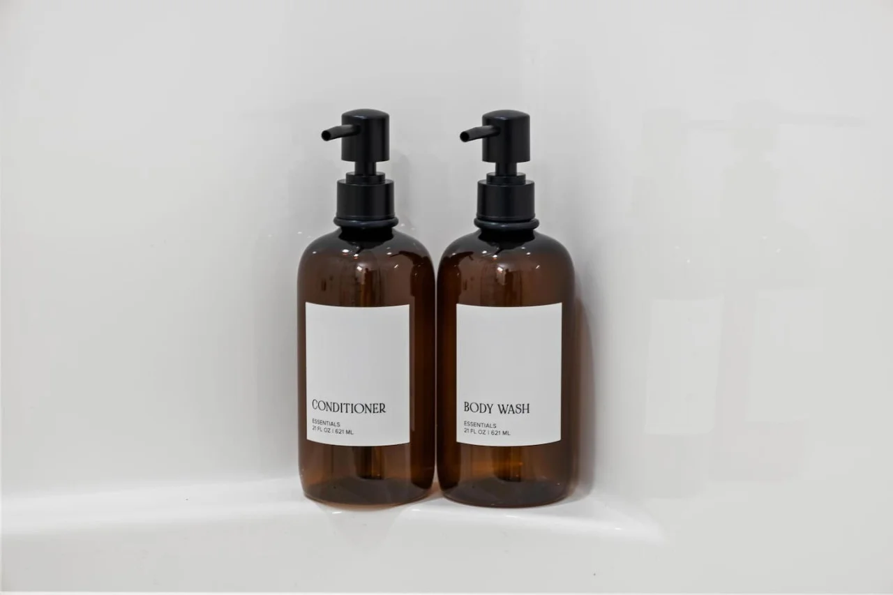 Immaculate bathroom featuring a spacious shower, fresh towels, and complimentary toiletries for a spa-like experience.