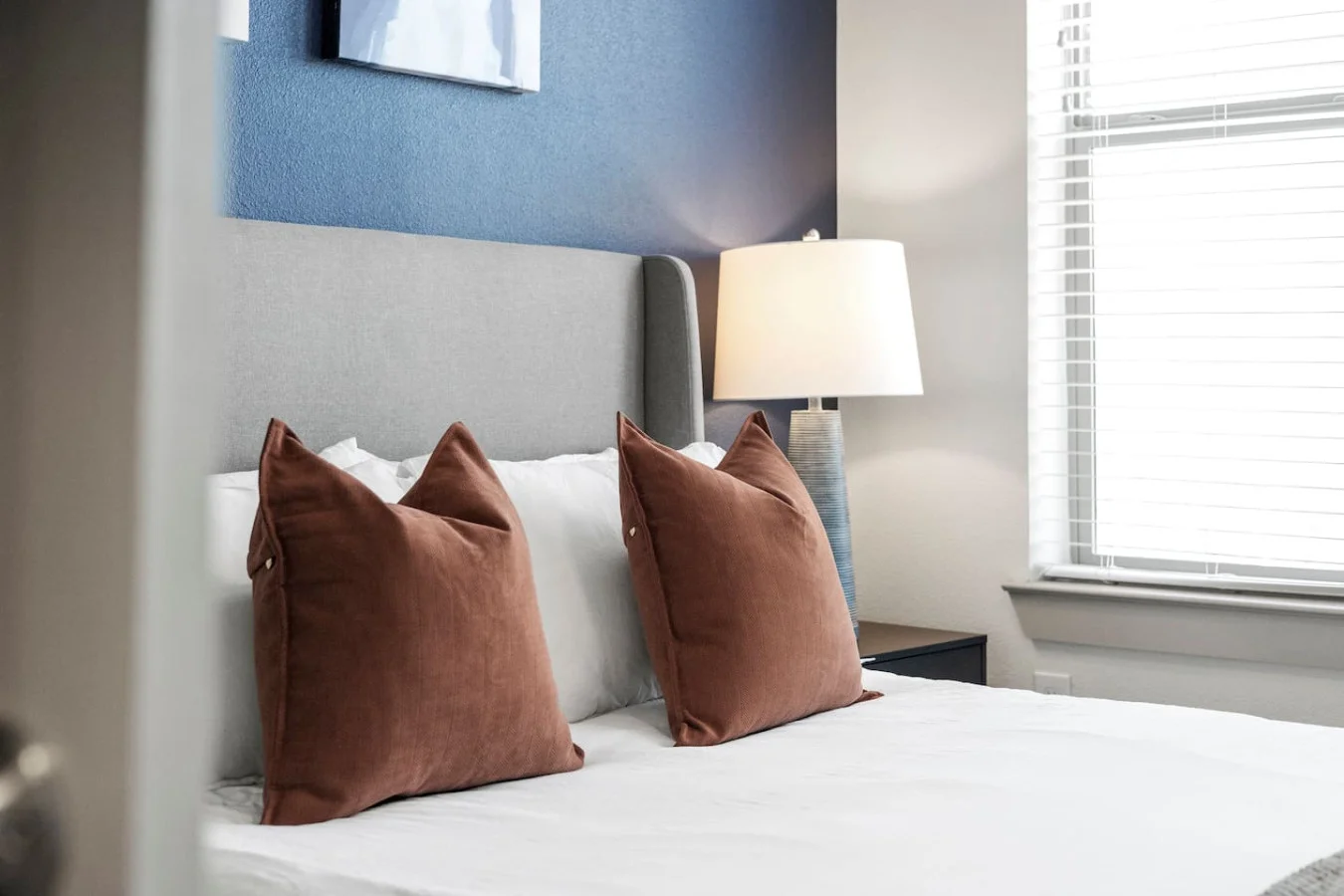 The bedroom offers a luxurious retreat, with a bed that promises restful nights and a room that feels like a private oasis.