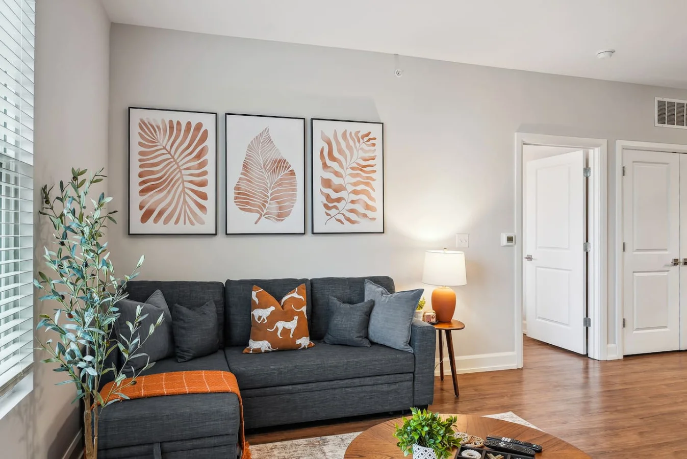 Bright and airy living room with plush seating, a large TV, and tasteful decor, creating the perfect space for relaxation and entertainment.