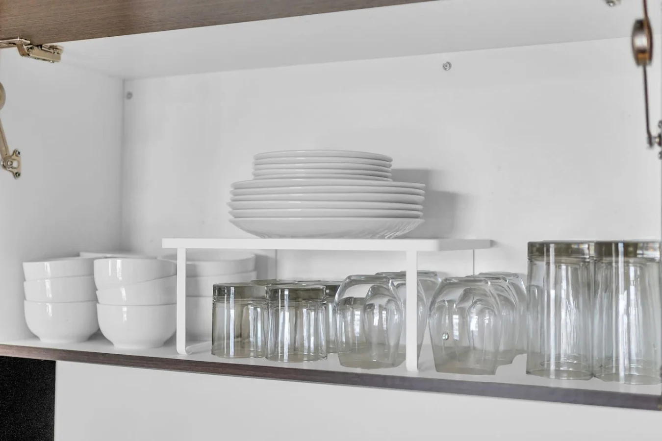 Kitchen cabinets stocked with cooking wares, glassware and silverwares, ideal for mixing up your favorite meals and drinks during your stay.