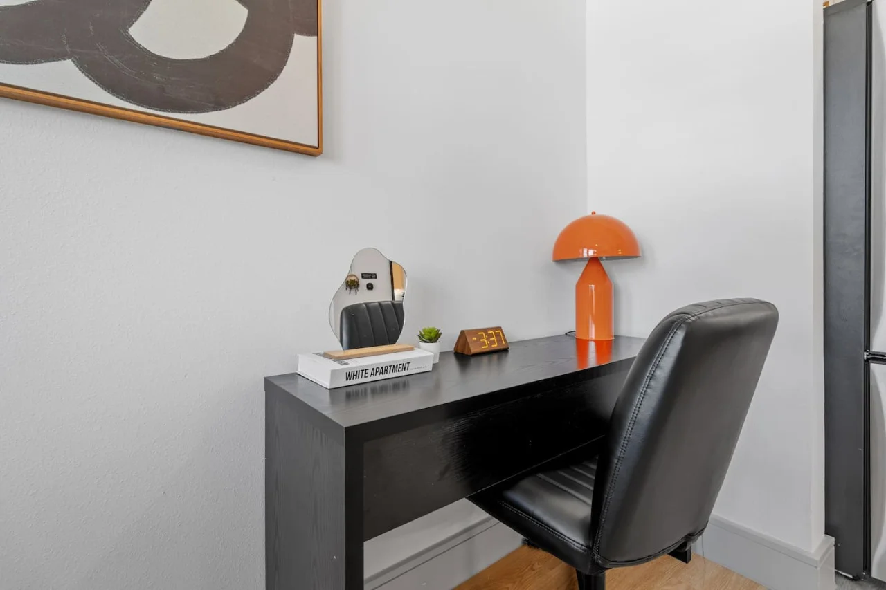 This cozy workspace with warm lighting, and a creative wall display, perfect for productivity.