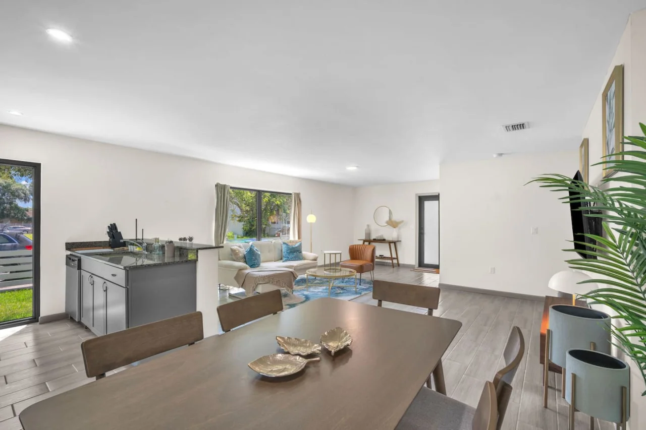 Spacious dining area with a mid-century modern table and chairs, seamlessly connected to the kitchen.