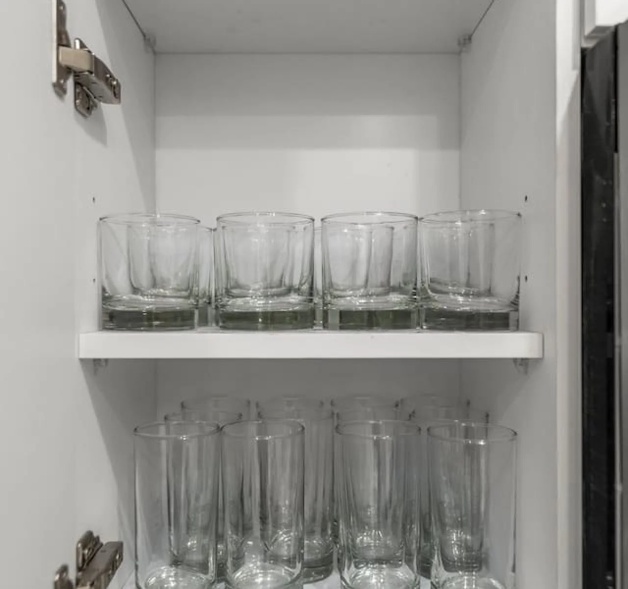 Kitchen cabinets stocked with cooking wares, glassware and silverwares, ideal for mixing up your favorite meals and drinks during your stay.