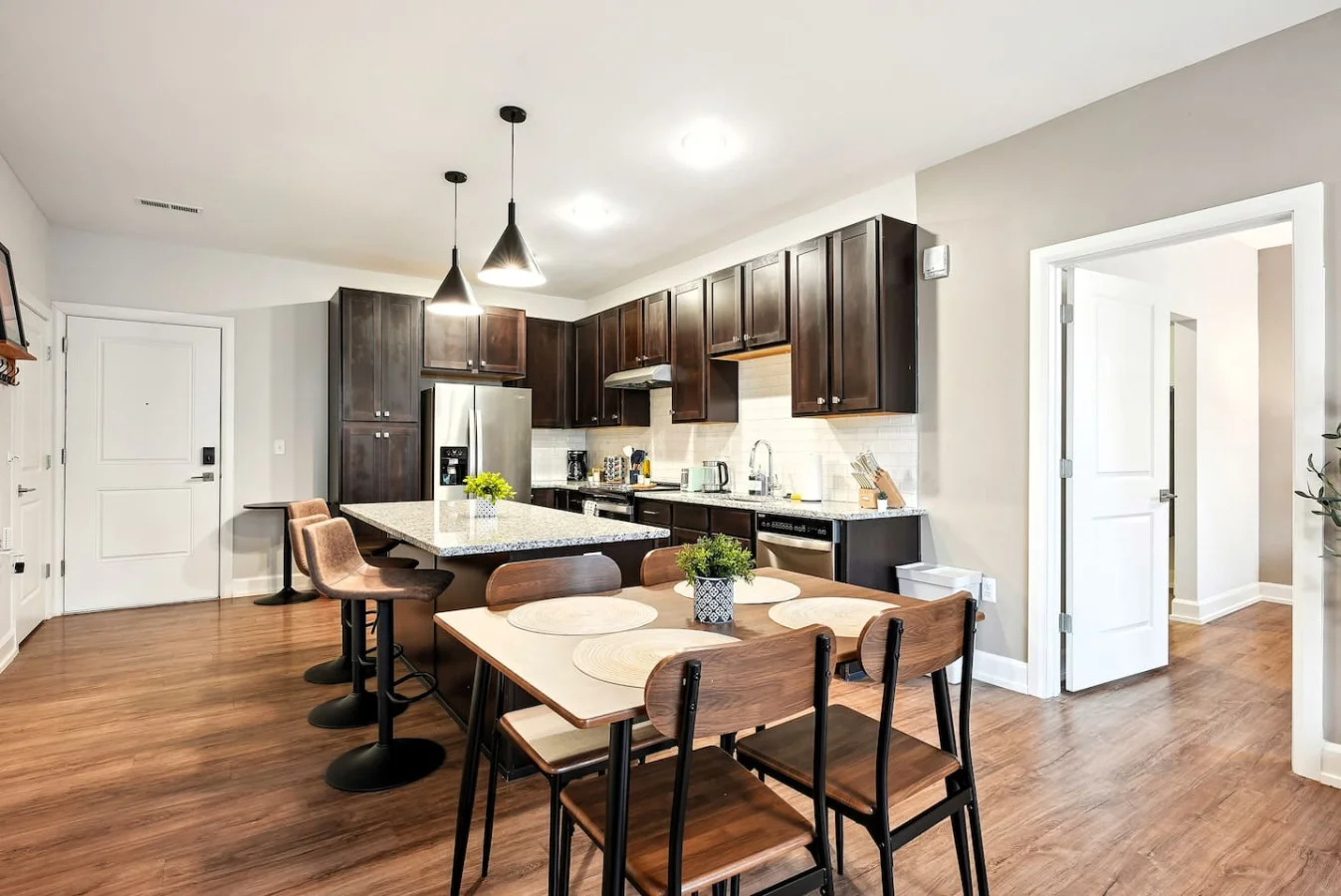 Elegant dining area with a large table and comfortable seating, perfect for gathering with family and friends for a meal.