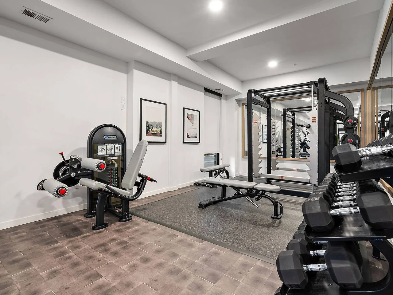 Dedicated space featuring a wide range of dumbbells, benches, and mirrors for strength and resistance training