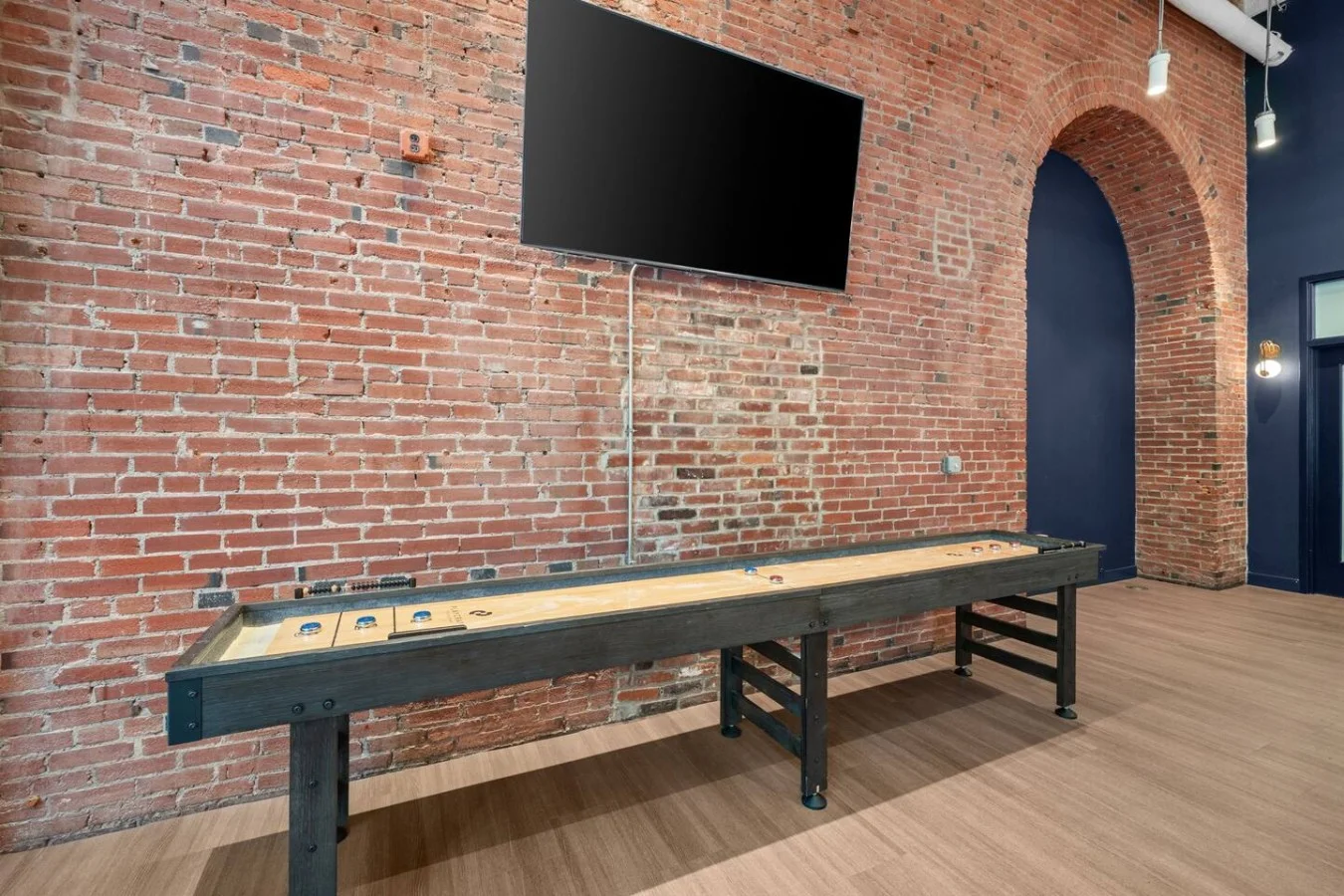 A classic shuffleboard table is one of many amenities to enjoy in our building's array of social spaces
