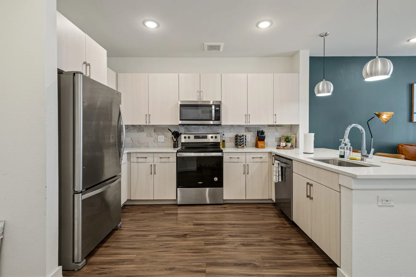 Sleek kitchen featuring stainless steel appliances, ample storage, and stylish lighting for a comfortable cooking experience.