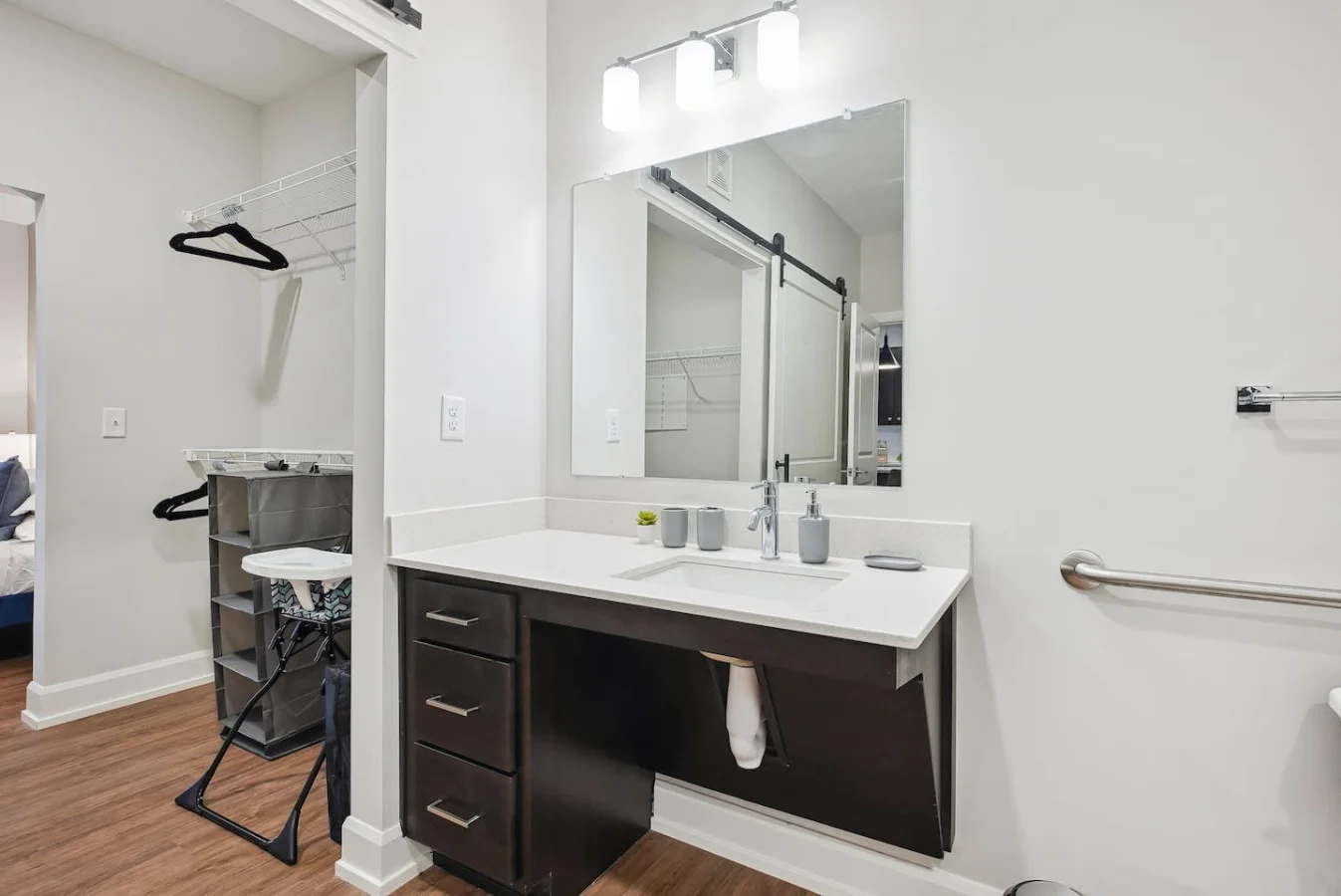 Sleek and clean bathroom vanity with modern fixtures, lush greenery, and premium hand soap. Refresh and unwind in style.