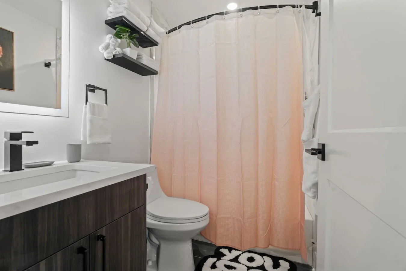 Fully Equipped Bathroom with Single Vanity and Backlit Mirror