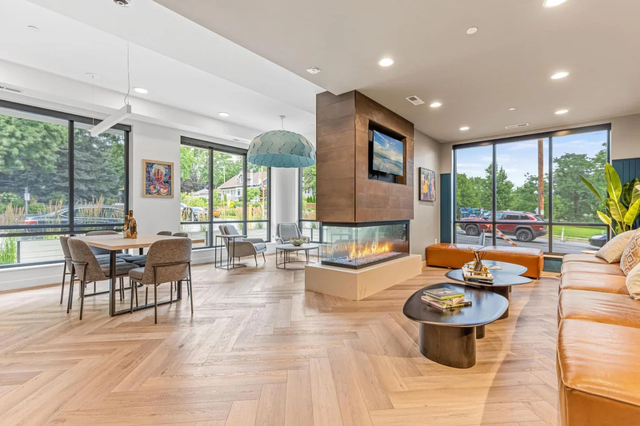 Spacious open-concept living and dining area featuring a vibrant sofa, modern furnishings, and a stylish entertainment setup—ideal for gatherings and relaxation.