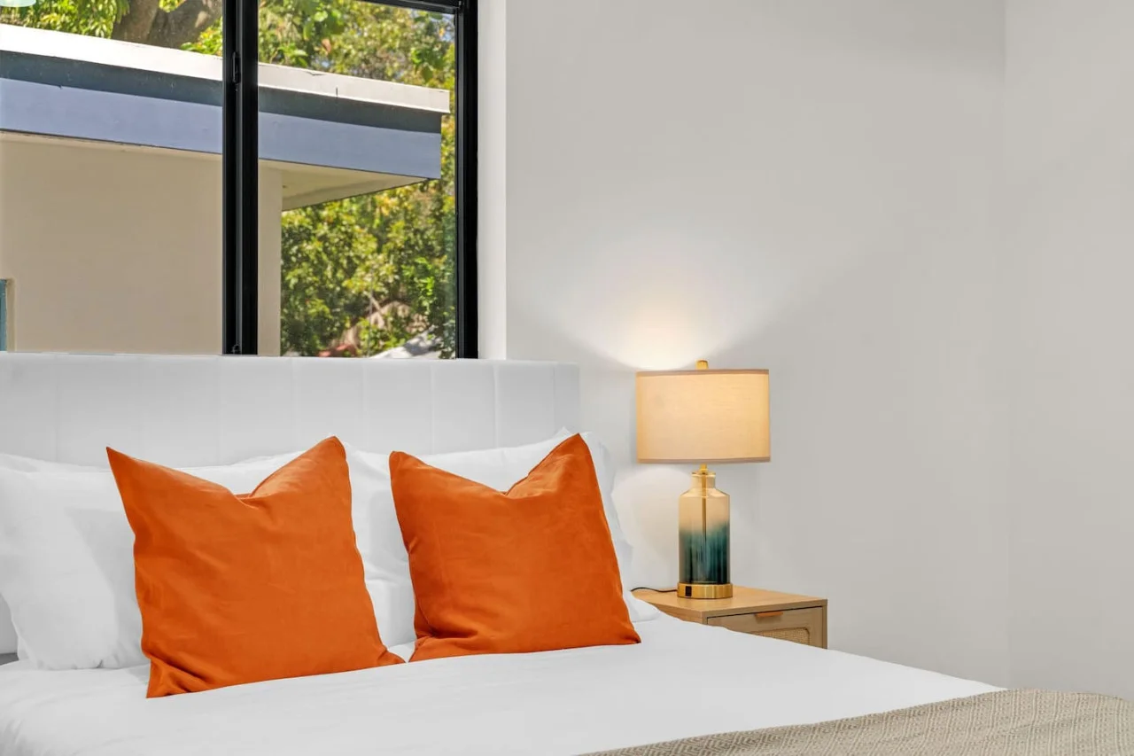 A closer look at the large window that fills the room with natural light, offering a serene view of greenery outside.