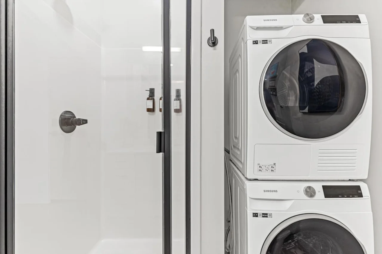 As you step into the laundry room, the modern appliances and ample storage space make it easy to keep things tidy.