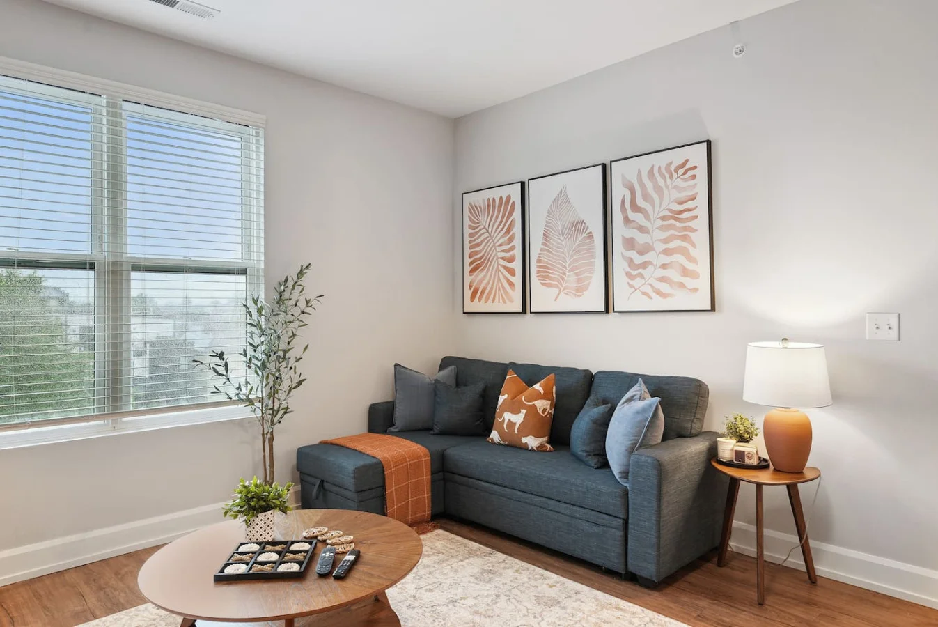 Bright and airy living room with plush seating, a large TV, and tasteful decor, creating the perfect space for relaxation and entertainment.