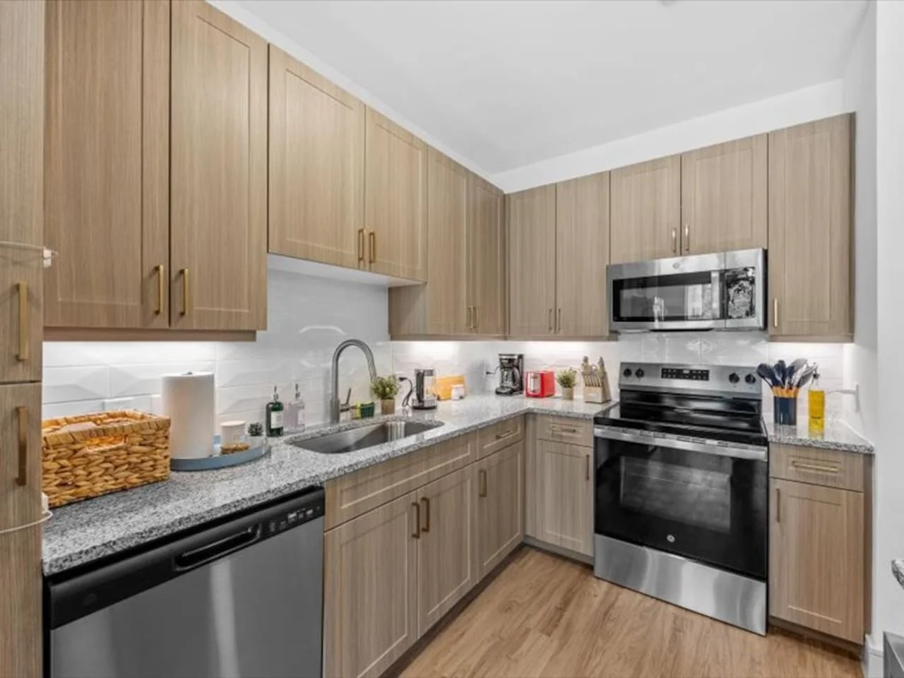 Cook with ease in this well-equipped kitchen featuring stainless steel appliances, ample cabinetry, and a stylish backsplash. Whether you're brewing coffee or preparing a gourmet meal, this space is designed for functionality and style, making every meal
