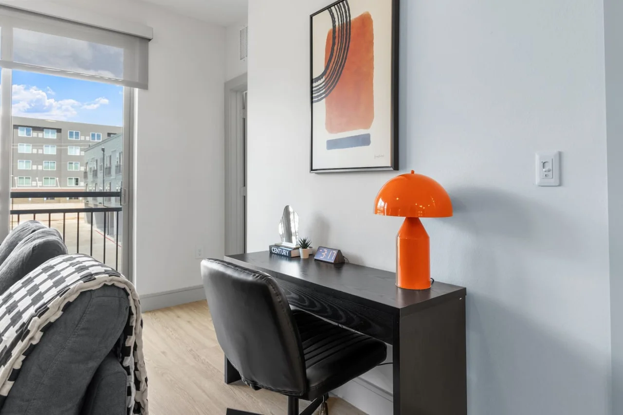 This cozy workspace with warm lighting, and a creative wall display, perfect for productivity.