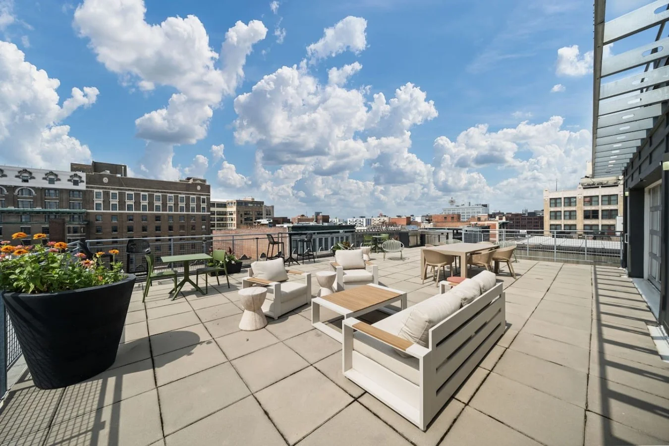 Comfortable patio furniture adorns the stylish rooftop terrace with sweeping city views.