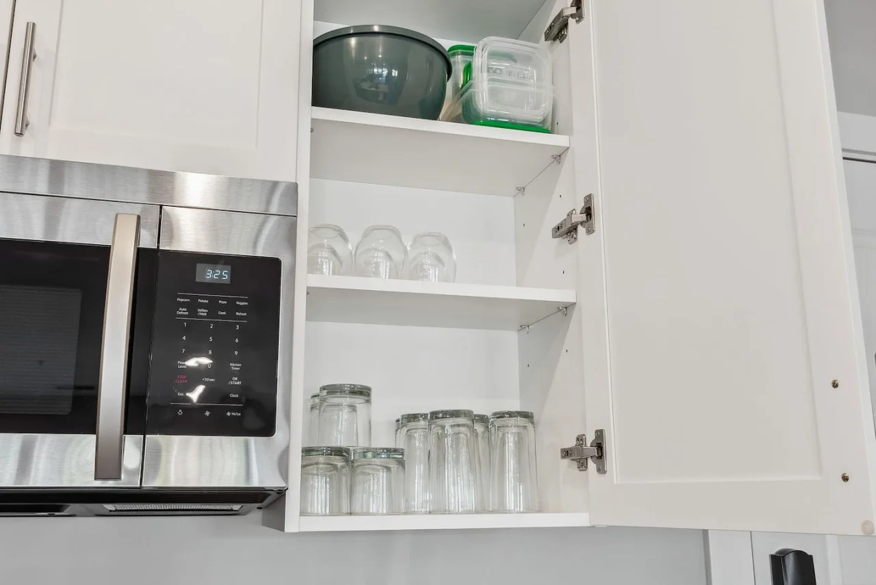Kitchen cabinets stocked with cooking wares, glassware and silverwares, ideal for mixing up your favorite meals and drinks during your stay.