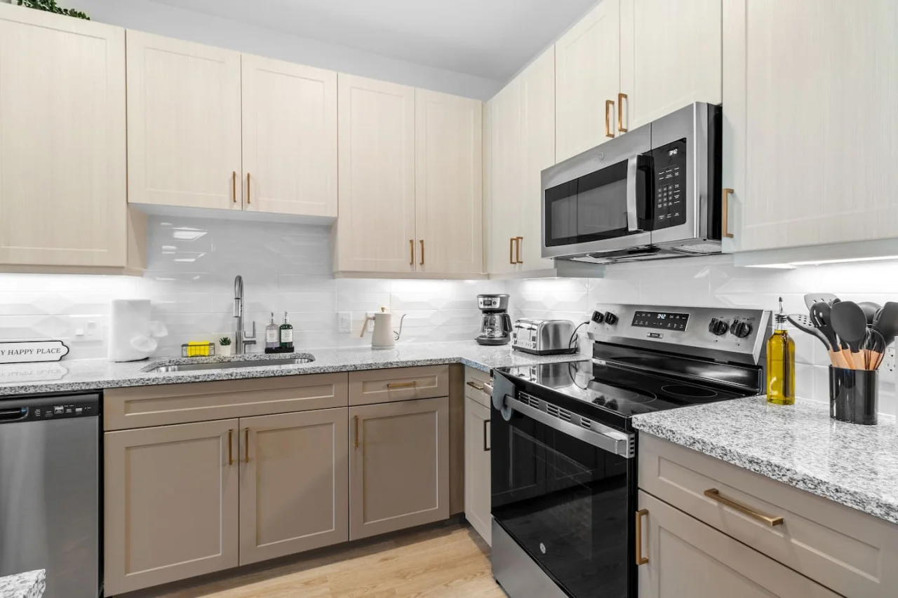 Cook with ease in this well-equipped kitchen featuring stainless steel appliances, ample cabinetry, and a stylish backsplash. Whether you're brewing coffee or preparing a gourmet meal, this space is designed for functionality and style, making every meal