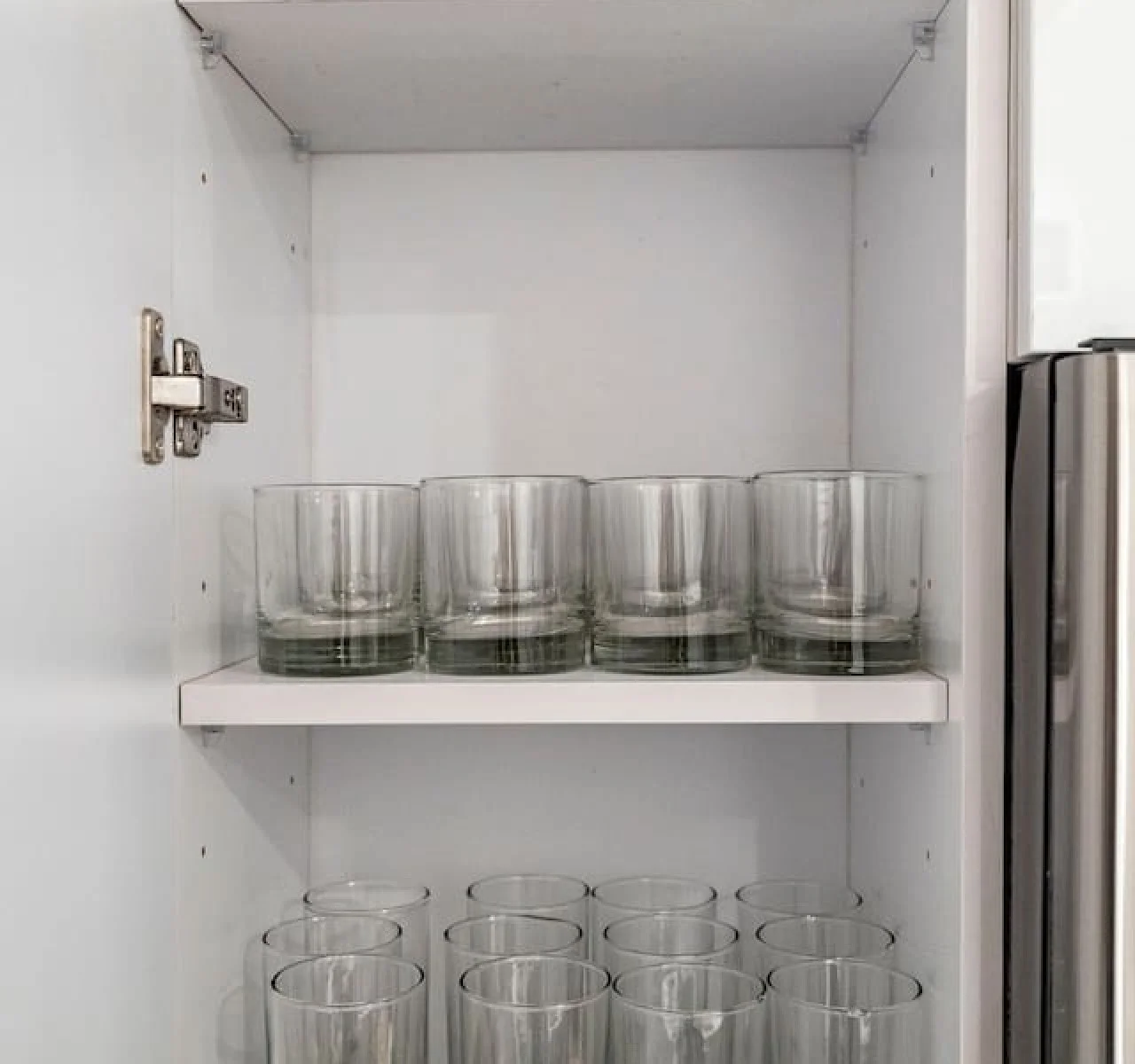 Kitchen cabinets stocked with cooking wares, glassware and silverwares, ideal for mixing up your favorite meals and drinks during your stay.