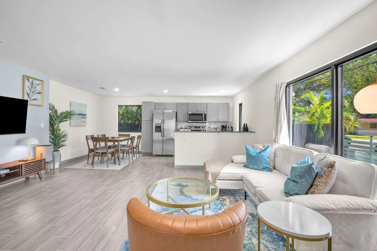 Living space offering a mix of bold and neutral tones, with abundant natural light for a vibrant ambiance.