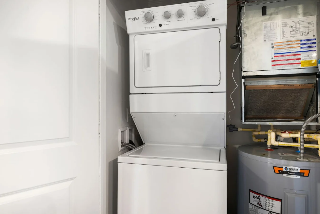 As you step into the laundry room, the modern appliances and ample storage space make it easy to keep things tidy.