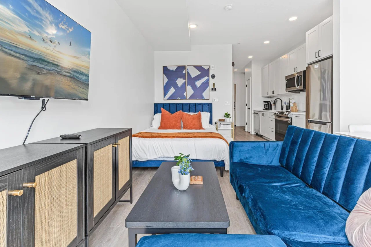 Bright and airy living room with plush seating, a large TV, and tasteful decor, creating the perfect space for relaxation and entertainment.