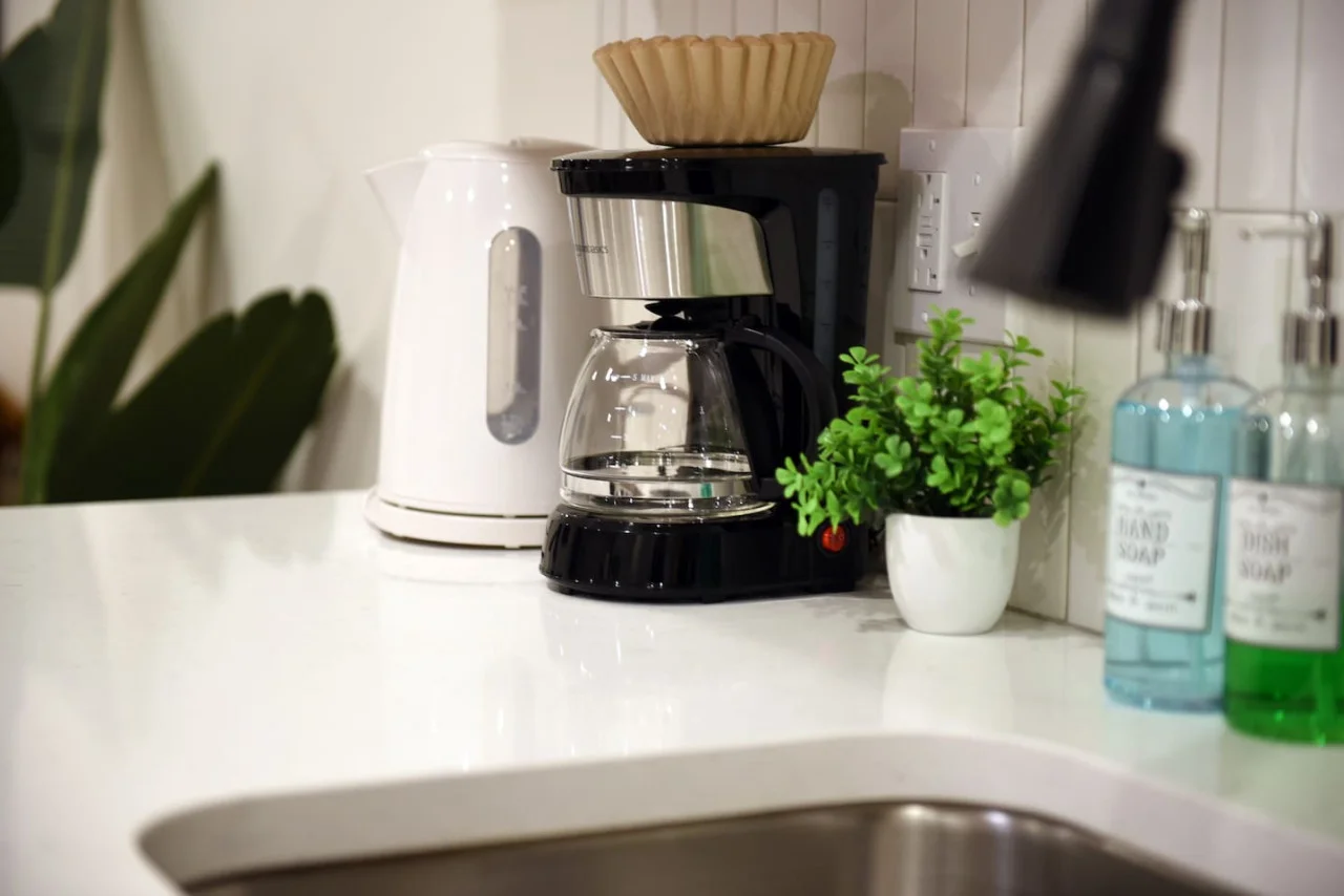 The coffee station is thoughtfully equipped with a variety of in-house consumables, including a selection of ground coffee, sweeteners, and creamers to suit every taste.
