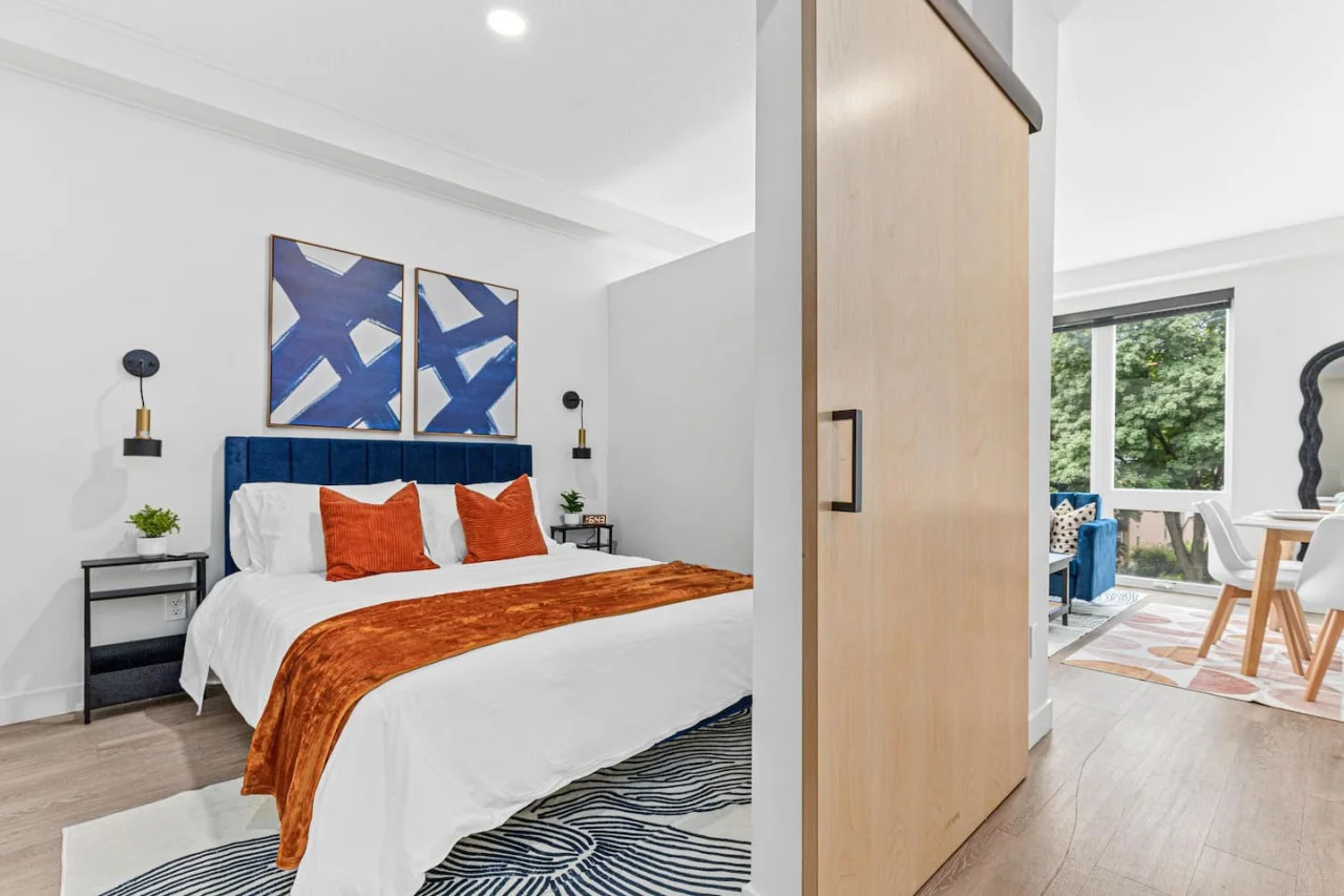 Comfortable Queen size bed - Side tables - Bedside lamps - Wall art - Area rug - Alarm clock, Extra pillows w/ Throw blanket - Sliding bedroom door.