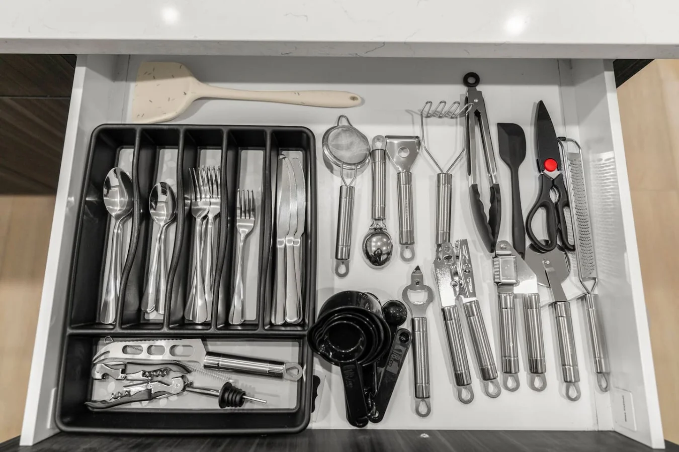 Everything you need in the kitchen: flatwares, strainer, spatula, tongs, scissor, measuring spoons, and more!