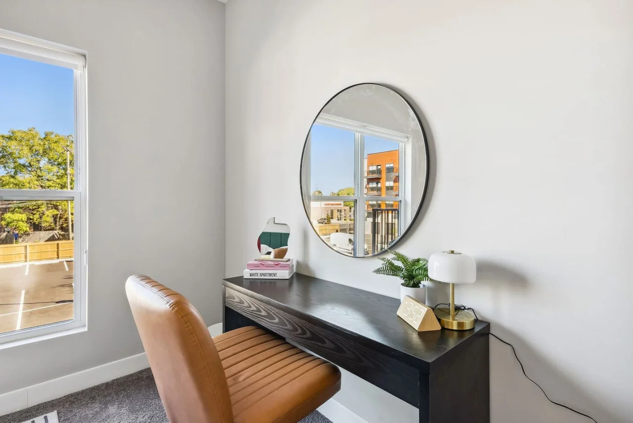 This cozy workspace in the master bedroom is perfect for productivity. Enjoy natural light, a comfortable chair, and a stylish desk setup. Ideal for work-from-home needs or planning your Dallas adventures.