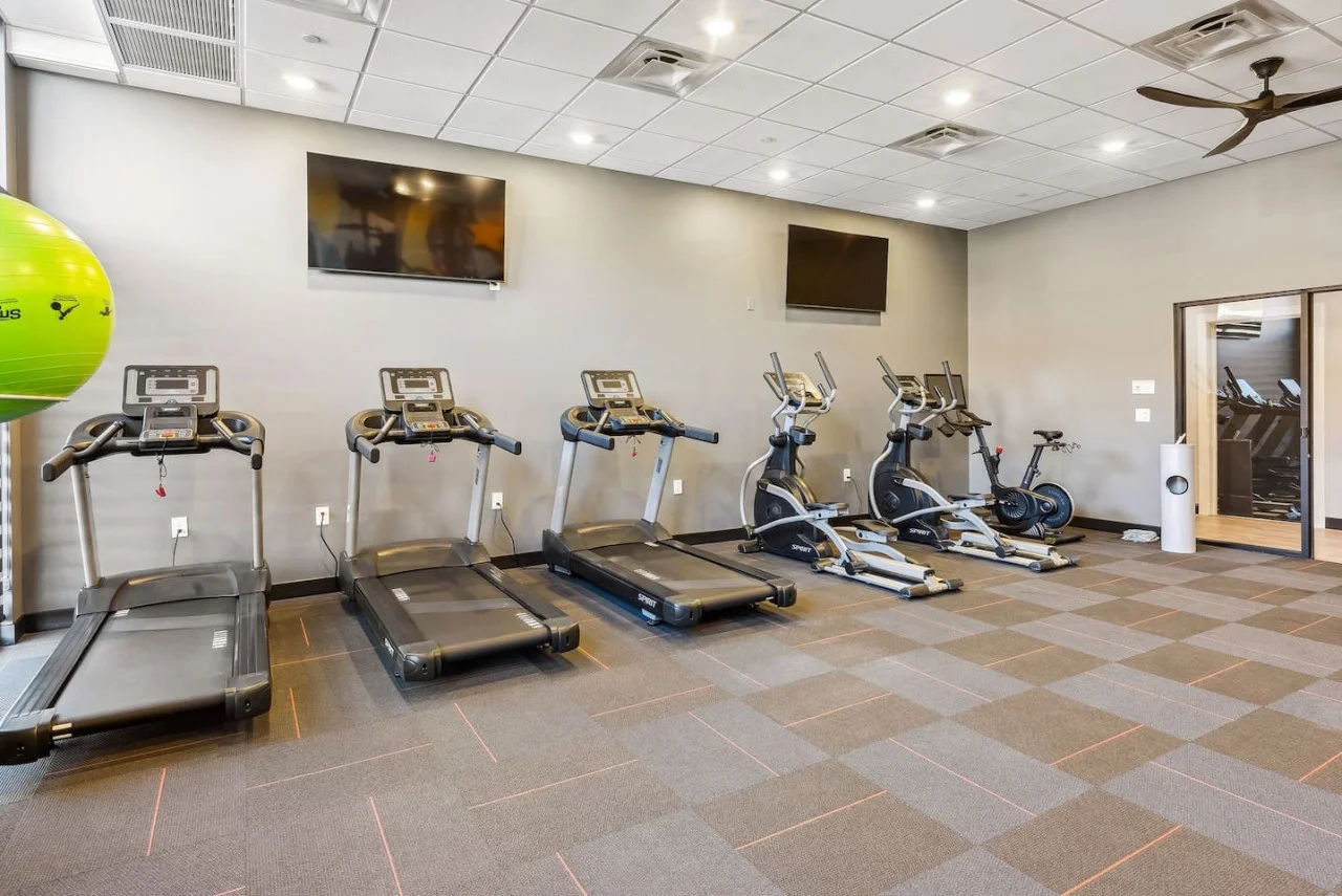 Open floor area with exercise mats, yoga balls, and foam rollers for warm-ups, stretching, or core exercises.
