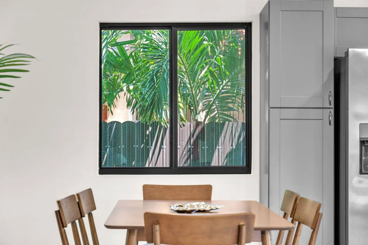 Dining area with gardeView of the front yard and street.n views through large windows, offering a delightful space for meals.