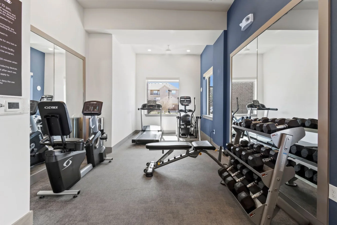 Dedicated space featuring a wide range of dumbbells, benches, and mirrors for strength and resistance training