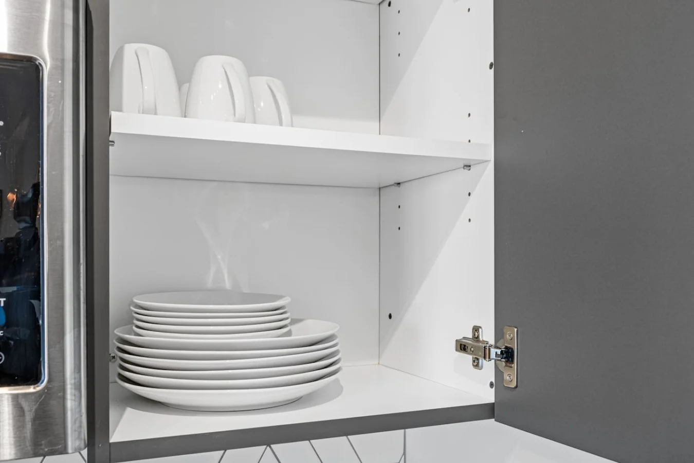 Kitchen cabinets stocked with cooking wares, glassware and silverwares, ideal for mixing up your favorite meals and drinks during your stay.