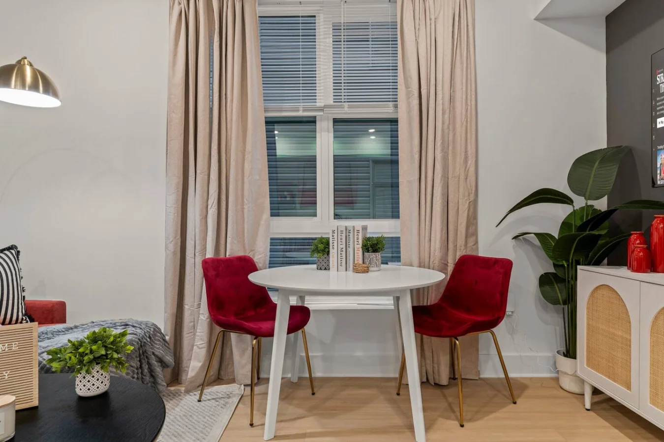 Compact dining table with accent chairs and decorative plants