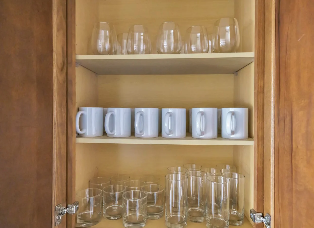 Kitchen cabinets stocked with cooking wares, glassware and silverwares, ideal for mixing up your favorite meals and drinks during your stay.
