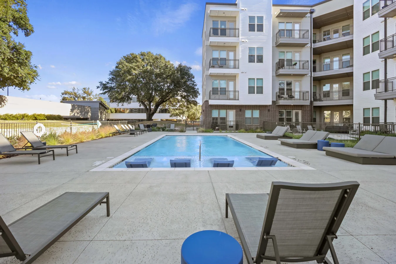 You can imagine yourself lounging by the pool, surrounded by greenery and the gentle sound of water.